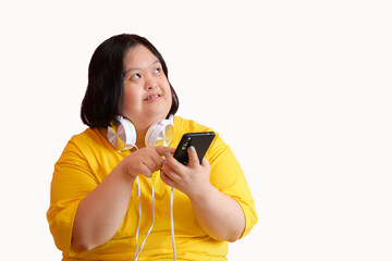 Image of a young woman with Down syndrome or a cerebral palsy student Listening to music and...