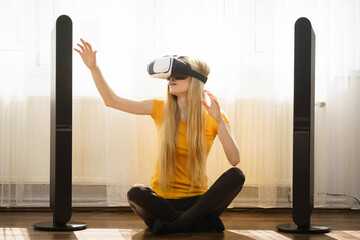 Girl wearing virtual reality goggles at home