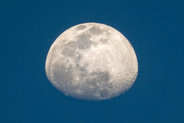 the waxing moon against the blue sky