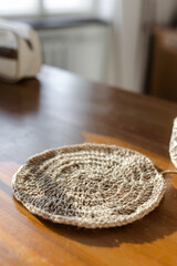 Handmade home decor made from organic jute fiber. round jute napkins, hot plate, table setting. crocheting. the concept of home decor and comfort in the eco style.