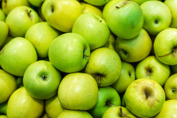 Green apples on the counter of a grocery store. Close-up