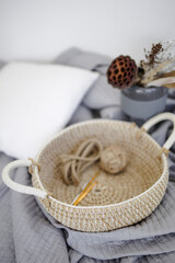 Handmade home decor made from organic jute fiber. wicker jute basket with handles on the bedspread. jute fiber and rope in the basket. the concept of home decor and comfort in the eco style.