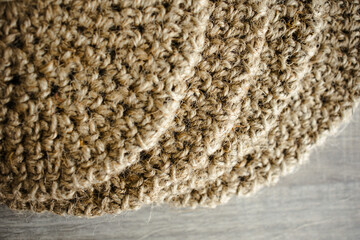 Handmade home decor made from organic jute fiber. four round jute napkins, a stand for hot drinks, table setting. the concept of long-term decor and comfort in the eco style