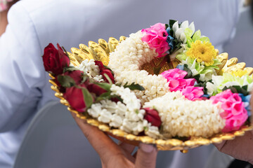Thai jasmine flower garland in golden pan.