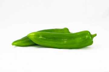 Two fresh green pepper isolated on a white background