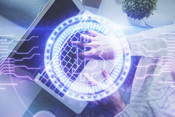 Double exposure of woman hands working on computer and blockchain theme hologram drawing. Top View. bitcoin cryptocurrency concept.