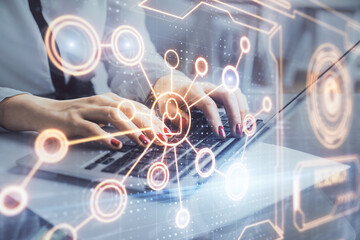 Double exposure of woman hands typing on computer and social network theme hologram drawing. People media concept.