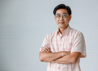 Portrait of warm personality senior older man wearing eyeglasses with smile face folding crossed...