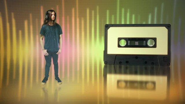 Audio Cassette Music Dance Young Man Vintage Technology. Young man with long hair enjoys music on his headphones with audio cassette in the background. Retro style
