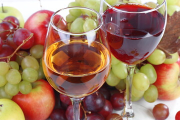 Still life with wine and fruits on a white background