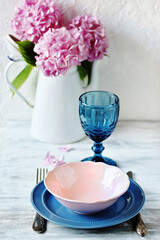 beautiful serving in blue and pink colors. pink hydrangea. colored blue glass in retro style. Colored Vintage-Style Goblets. 