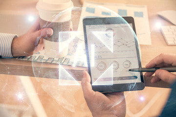 Multi exposure of man's hands holding and using a digital device and data theme drawing. Innovation...