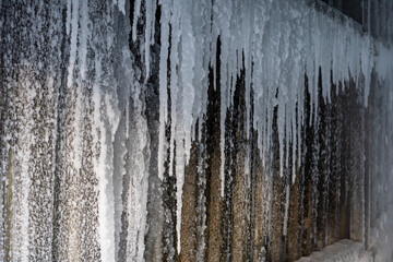 ice metal fence. formation of ice and icicles.