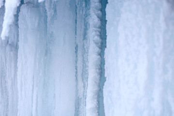 Ice caves. Formation of large icicles. Ice stalactites 