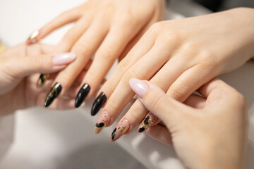 Obraz na płótnie Canvas elegant female hands with long nails after procedure manicure in a beauty salon