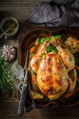 Roasted chicken with thyme and carrots. Grilled chicken with herbs.