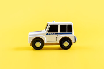 Children's toy, car on a yellow background. Police car. Concept. Isolate. Copy space.