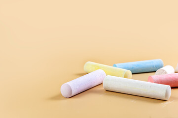 Colored crayons on a beige background. Child Game. Hobby. Child development and leisure concept. Copy space.