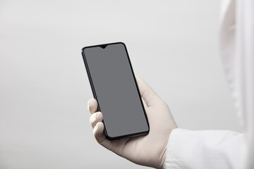 hands with gloves and phone with gray screen, white background