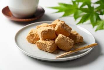 Warabi mochi and Japanese tea placed on a white background