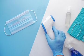 Hand holding infrared thermometer to measuring temperature.
