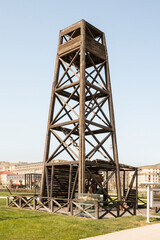 The method of oil production in the early 20th century. Wooden drilling rig. Flammable production.