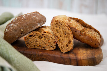Delicious carrot rolls, sliced, homemade with a crust on a wooden board.