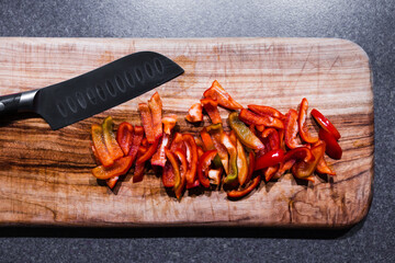 freshly picked mini red bell pepper capsicums chopped up on cutting board, simple ingredients concept