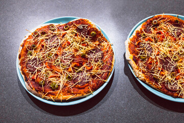 vegan pizza with plant-based salami slices and capsicum topped with dairy free cheese, healthy plant-based food