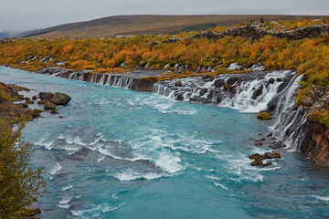 Unusual blue waterfall in Iceland Hraunfossar