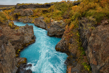 Unusual blue waterfall in Iceland Hraunfossar