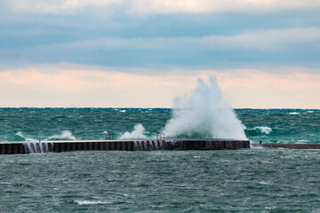 powerful crashing waves of lake Michigan overpowering a jetty