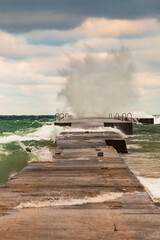 powerful crashing waves of lake Michigan overpowering a jetty
