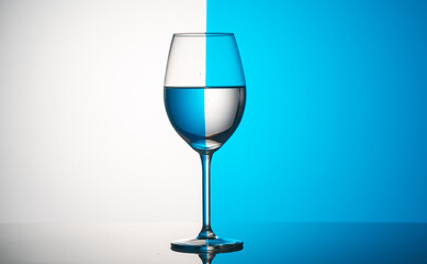 Glass wine glasses on a colored background