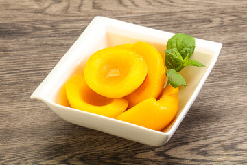 Sweet ripe canned peaches with mint