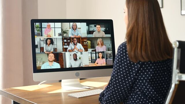 Diverse multiracial people involved video meeting, video conference. Woman using computer app for video connection for many colleagues together on the distance, screen with a lot of employees profiles