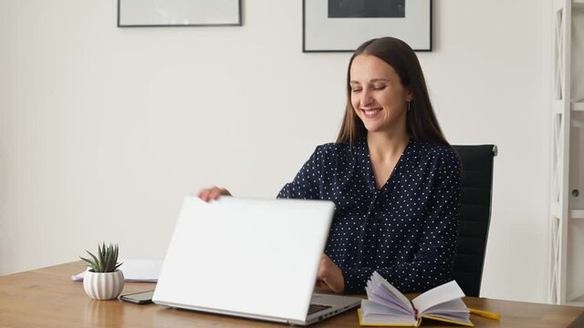 Smiling female manager finishing her works at the office, closing laptop computer looks aside dreamly, satisfied woman feels good and rests after productive day, happy with well done project