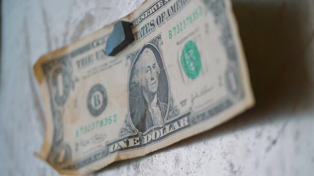 One dollar on the wall in 4k slow motion 60fps
