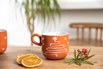 colorful handmade ceramic coffee mug on wooden table