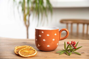 colorful handmade ceramic coffee mug on wooden table