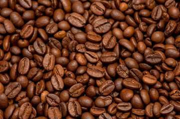Roasted coffee beans, top view. Dark background