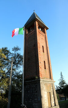Italian flag flying and the bell tower of a church