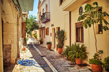 Fototapeta na wymiar Small cozy sunny Greek street.