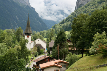 Picturesque catholic church in verdant forested Lauterbrunnen valley, Switzerland