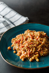 Stewed cabbage with chickpeas and carrots, lean vegetarian dish, healthy food, stewed vegetables