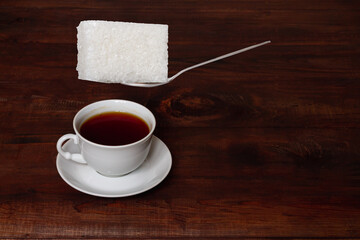 Putting a huge lump of sweet sugar in a cup of tea, the concept of excess, surplus, overabundance, overeating