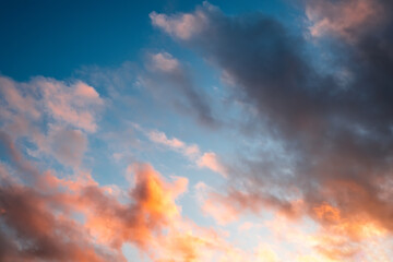Sunset sky landscape. Red-yellow clouds and blue sky.