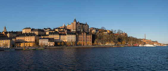Fototapeta premium View over old houses in the Södermalm district a spring day at sunrise in Stockholm from the Riddarholmen island