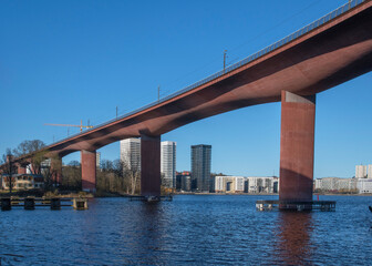 Train bridge in Stockholm with the district Liljeholmen at the waterfront in the background.