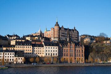 Fototapeta na wymiar View over old houses in the Södermalm district a spring day at sunrise in Stockholm from the Riddarholmen island